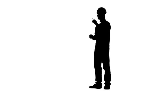 Construction worker kneeling to open metal toolbox isolated on bright white background