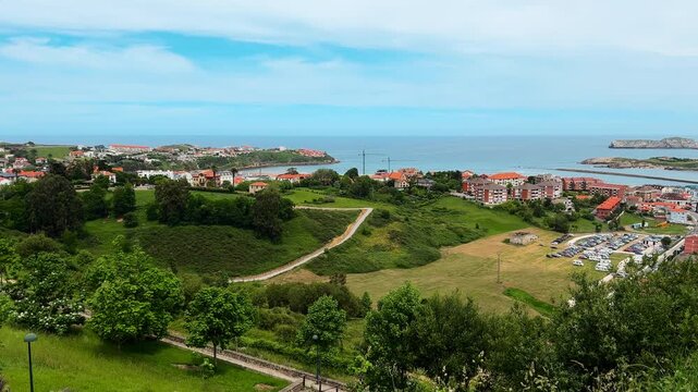 Suances coastal town panoramic view, Cantabria, Spain. Elevated green landscape over ocean coastline and Cantabrian Sea. High quality 4k footage