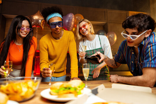 Group of friends making party at home on new year evening