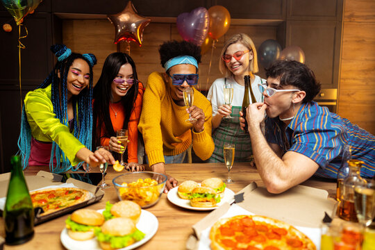Group of friends making party at home on new year evening