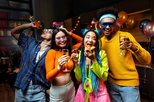 Group of friends making party at home on new year evening