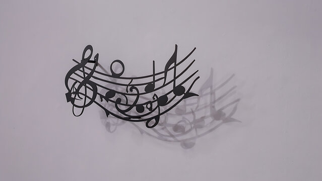Metallic musical notes wall decor with treble clef low angle shot