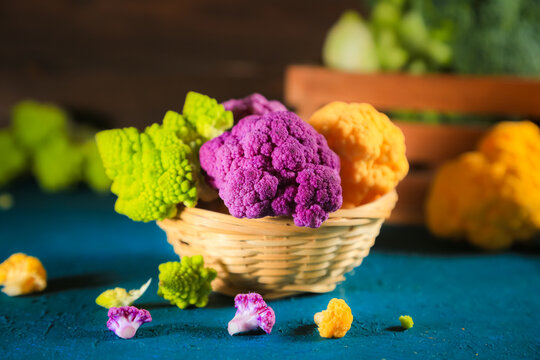 Multicolored cauliflower in a wicker bowl. Rustic still life.