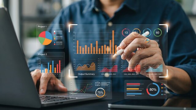 Man analyzing digital financial charts with stylus and laptop in modern office setting during data visualization