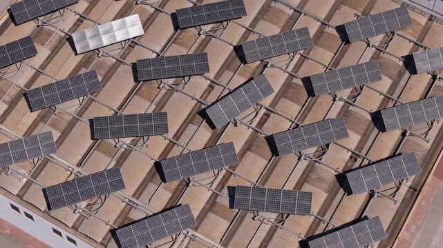 Solar panels generating clean electricity on the rooftop of a large industrial building. Sustainable technology for a green future