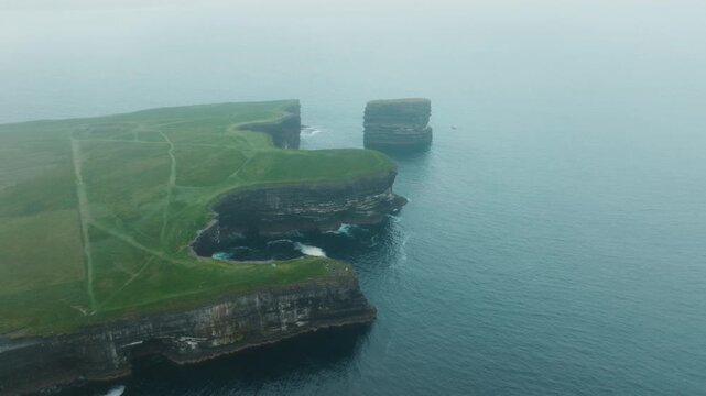 Aerial view of Dun Briste sea stack off foggy cliffs at Downpatrick Head