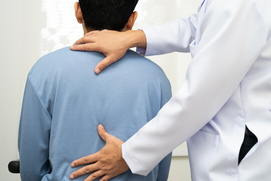 Physical therapy, Asian therapist doctor treat perform pain young man in hospital.
