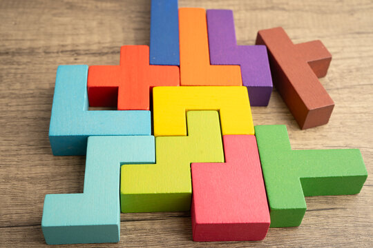 Logical thinking and problem solving creative business solution concept, wooden puzzle geometric shape block shape.