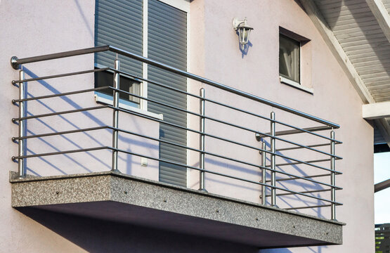 Stainless steel railing on a balcony. Modern high-gloss stainless steel balustrade with a sleek and contemporary design.