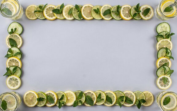 Down frame of lemon and cucumber slices with mint leaves