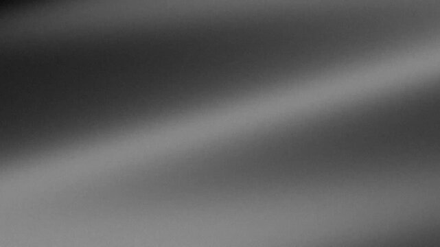 Abstract grey background with grainy texture and soft light reflection