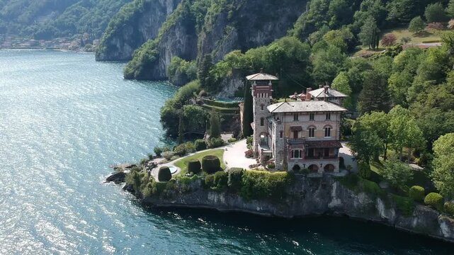 Historic Villa La Gaeta captured by drone on Lake Como, Italy, with mountains and blue water