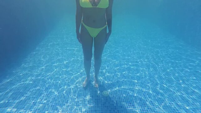 Sexy Bikini Woman with Natural Breasts Jumping Underwater in Pool