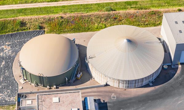 Aerial view of anaerobic digestion tanks at a biogas plant with processing buildings and technical infrastructure for renewable energy in Le Pouzin, Auvergne-Rhone-Alpes, France.