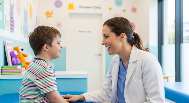 Friendly pediatrician listening to young boy patient in bright colorful children clinic room. Smiling female pediatrician creating comforting environment for child care. Concept pediatrician care.