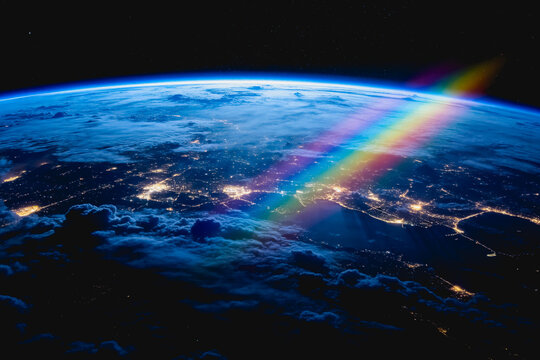 A view of Earth from outer space at night, showing atmosphere, clouds, city lights and a colorful light beam across the planet.