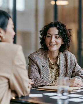 HR advisor and employee having supportive performance conversation in office