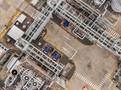 Aerial view of Parque Electrico Los Mina power plant, showing industrial infrastructure, metal piping, and concrete ground markings in Santo Domingo, Santo Domingo, Dominican Republic.