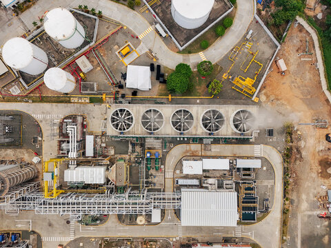 Aerial view of Parque Electrico Los Mina featuring large industrial cooling fans, storage tanks, and complex infrastructure in Santo Domingo, Santo Domingo, Dominican Republic.