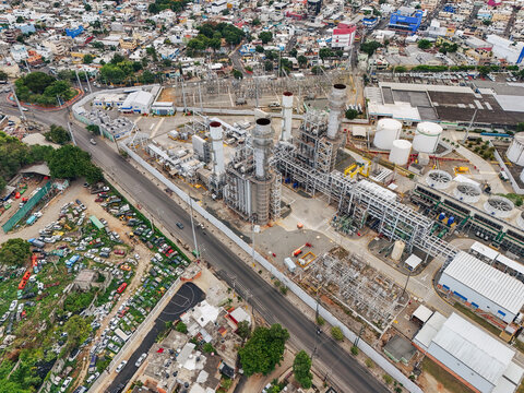 Aerial view of Parque Electrico Los Mina power plant with industrial chimneys, storage tanks, and electrical infrastructure in Santo Domingo, Santo Domingo, Dominican Republic.