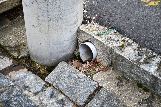 drainage on road kirb gutter and old bluestone paver blocks