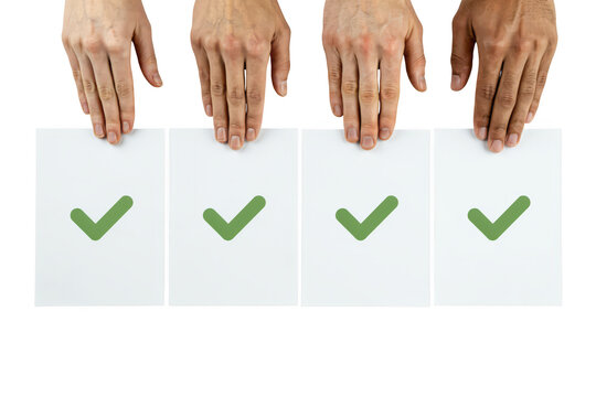 Diverse hands holding papers with green checkmarks for approval and voting