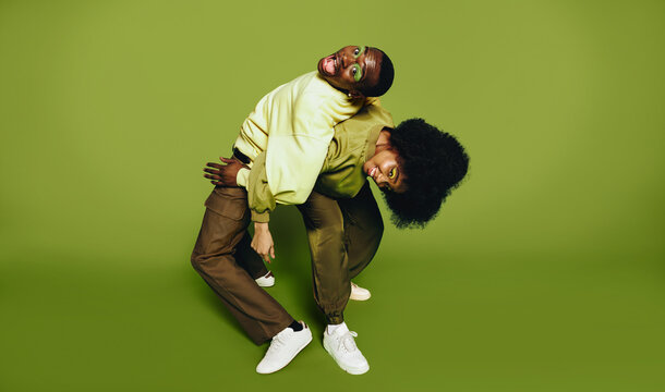 Hip hop friends dance together in the studio with playful movement and trust