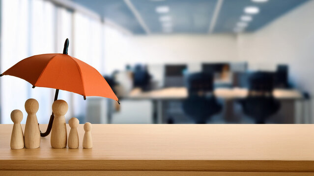 Wooden family figures and umbrella with blurred office background banner.