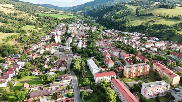 Aerial view of the town of Tisovec with residential buildings, green hills, and surrounding landscape in Tisovec, Banska Bystrica Region, Slovakia.