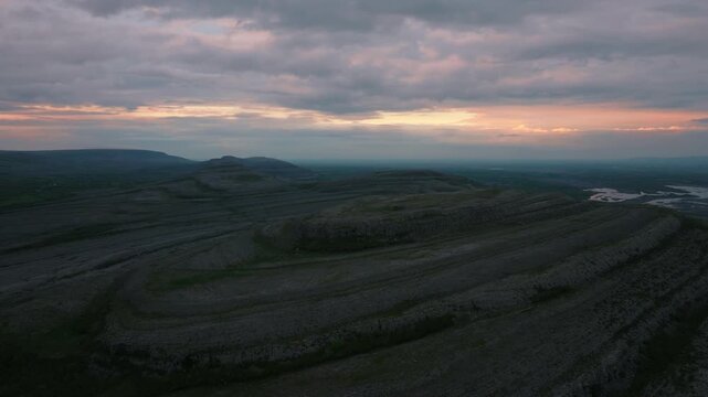 Aerial view of karst limestone pavement landscape in Burren region during sunset.
