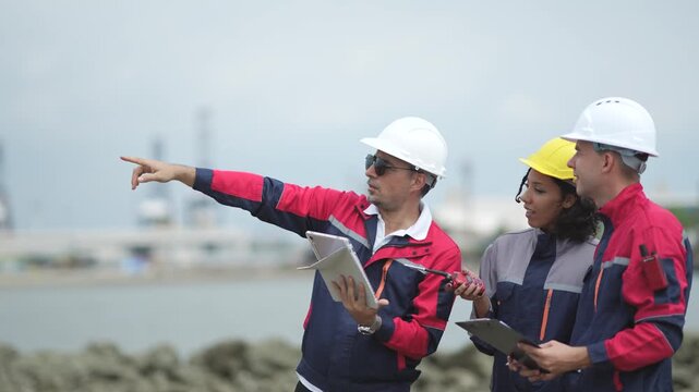 Engineers checking cargo ship operation at seaport, tablet data, walkie talkie communication, maritime industry, vessel inspection, shipping logistics, port teamwork.