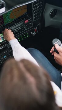 Pilot and copilot preparing for takeoff inside a cockpit