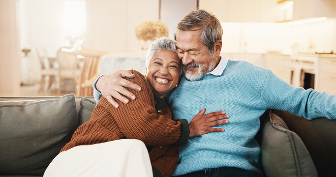 Senior, couple and relax in living room with hug, smile and bonding together for retirement wellness. Portrait, happy married people and pensioner in home with embrace, romantic relationship or love.