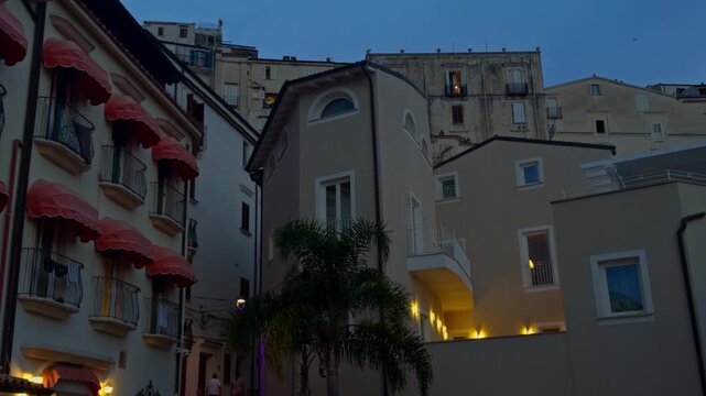 Picturesque alleyway winding through historic buildings in the charming old town of sperlonga, italy, illuminated at dusk