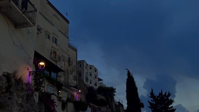 Intense lightning striking during a summer storm over the historic village of sperlonga, italy. Dramatic flashes illuminate the ancient buildings