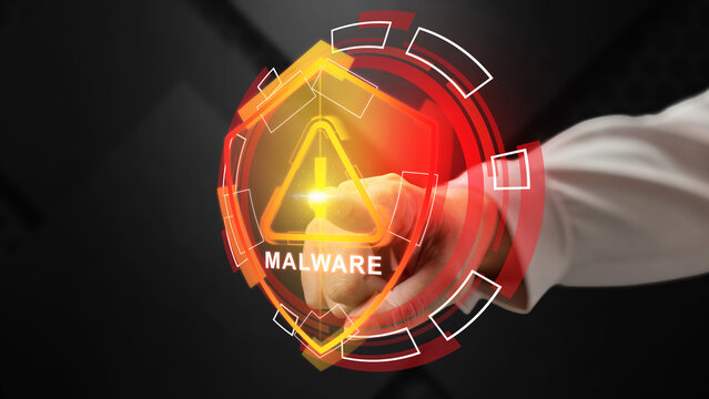 Hand touching a glowing digital interface with a shield icon and the word malware, representing cybersecurity threat detection and virus warning. Cybersecurity concept