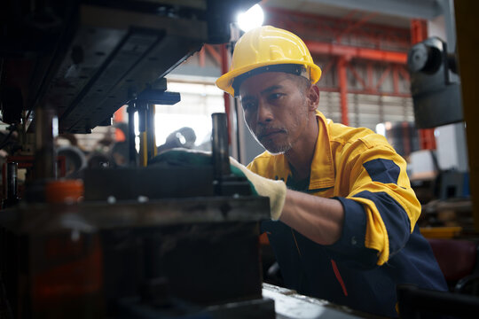 Technician Operating Industrial Machinery in a Manufacturing Facility for Engineering and Training Applications