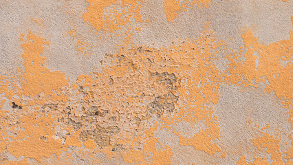 Fototapeta premium A concrete wall with faded yellow paint