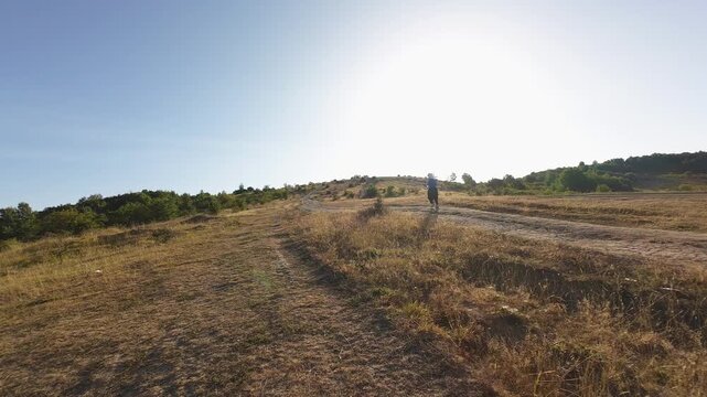 Trail running woman determined run through rural European hillside