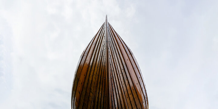 Wooden boat bow against cloudy sky traveling concept