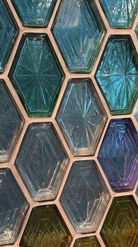 Colorful hexagonal glass tiles create geometric pattern for vibrant interior design background