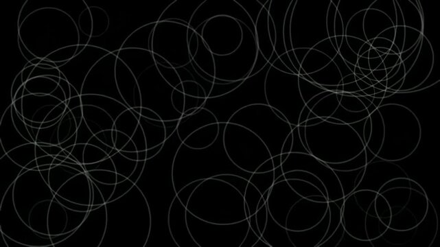 Abstract background with overlapping white circular outlines on a black surface.