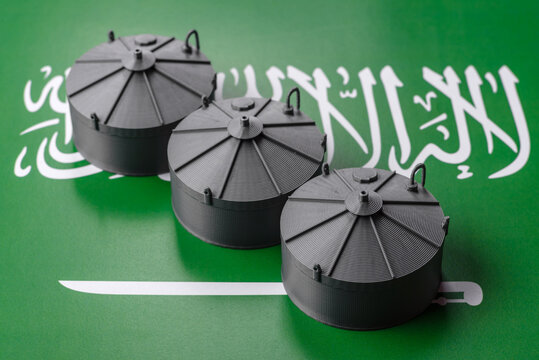 Liquefied gas storage tanks set against the Saudi Arabian flag, concept of supply and distribution