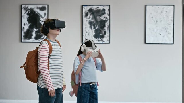 Caucasian boy and girl wearing virtual reality headsets exploring digital art exhibition in gallery. Ideal for promoting interactive education, EdTech, and modern museum experiences