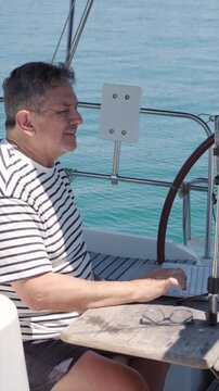 Digital nomad working remotely on a sailboat