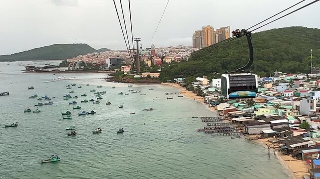 Sunset town, Phu Quoc, Vietnam. Aerial view of An Thoi harbor with coastal fishermen village, fishing boats, turquoise sea and modern cable car ride. Modern Hon Thom cable car cabin