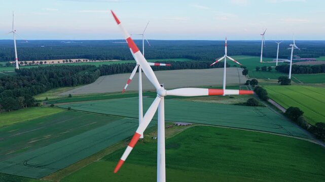 Agricultural harvest. Crop cultivation. Wind turbines farm. Green energy. Wind mill renewable electric energy production. Wind mill for renewable electric energy production. Windmill in rural area