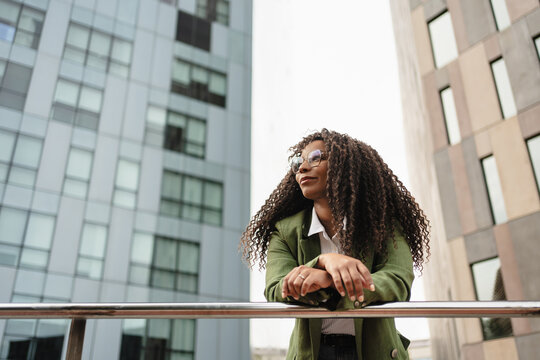 Pensive African American professional Business Woman in the city looking to the side - Woman inspiration