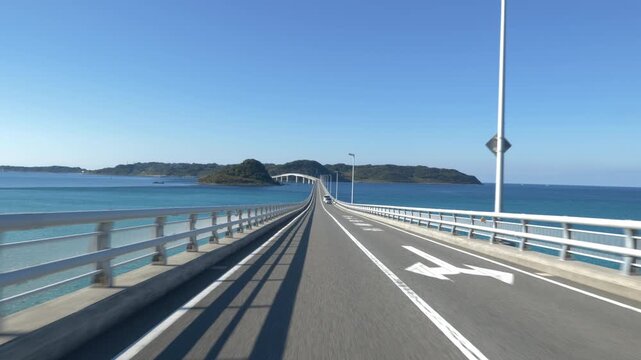 Driver's POV Crossing a Bridge Over Tropical Blue Waters with Oncoming Traffic, Tsunoshima Bridge, Shimonoseki City, Yamaguchi Prefecture, Japan (Horizontal | Real Time | Static)