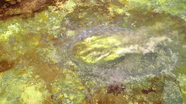 Aerial view of the vibrant mineral deposits and steaming vents at the Dalol Geothermal Area in Dalol, Afar, Ethiopia.